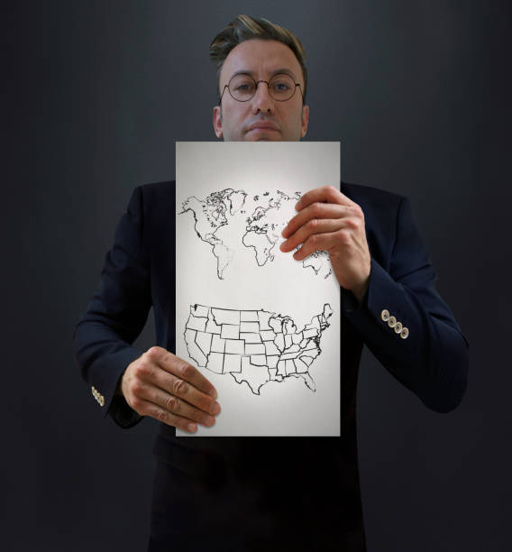 istock Businessman Showing USA and World Map Drawing 687210140
