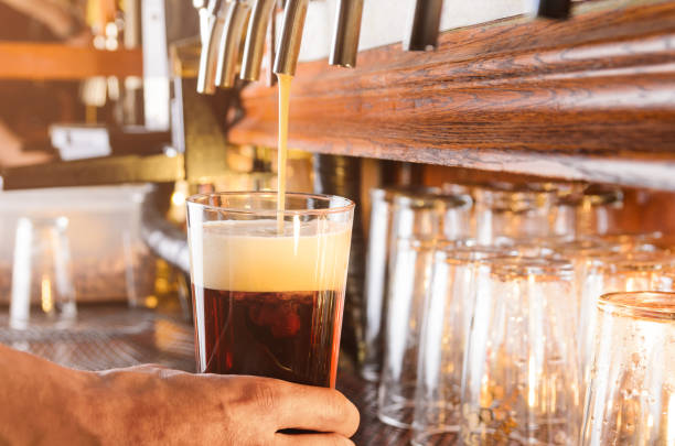 istock Barman is serving beer from faucet 687210566