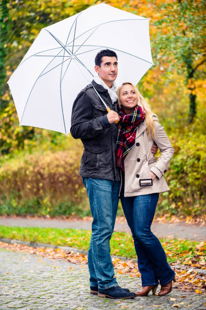 istock Couple enjoying fall day having walk despite the rain 687218806