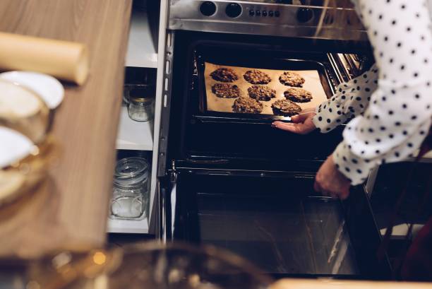 istock Cafe employee puts cookies to the oven 687228790