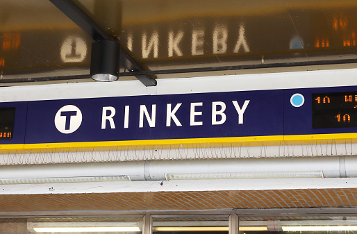 Rinkeby, Sweden - May 23, 2016: Closeup of the sign indicating the name of the metro station in the Stockholm suburb of Rinkeby.