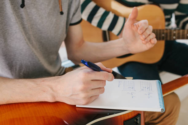 istock Learning to play the guitar. Music education and extracurricular lessons. 687235356