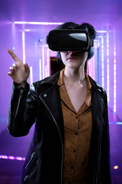 istock Female Wearing a VR Headset in a Virtual World 687240024