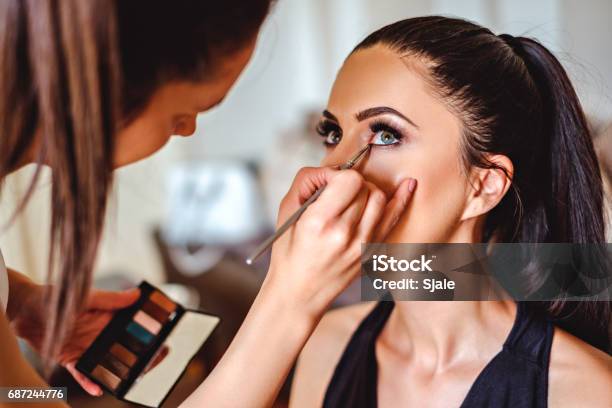 Makeup Artist Applying Eyeshadow On A Girl Stock Photo - Download Image Now - Make-Up, Make-Up Artist, Professional Occupation