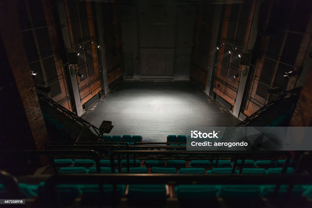 empty theater stage empty theater stage, no audience and light at the center Stage Theater Stock Photo