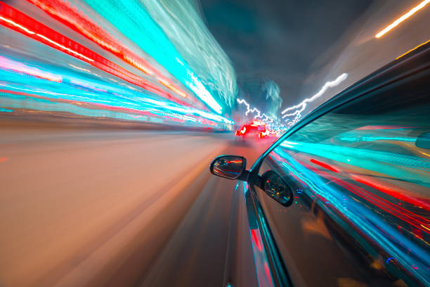 istock View from Side of Car moving in a night city 687262236