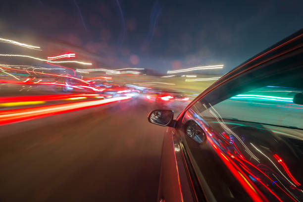 istock View from Side of Car moving in a night city 687268638
