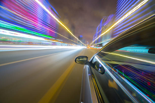 istock View from Side of Car moving in a night city 687273668
