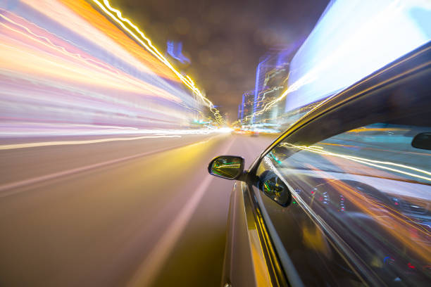 istock View from Side of Car moving in a night city 687273698