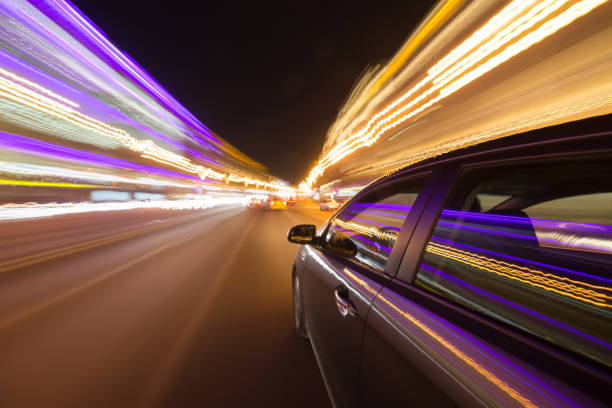 istock View from Side of Car moving in a night city 687280752
