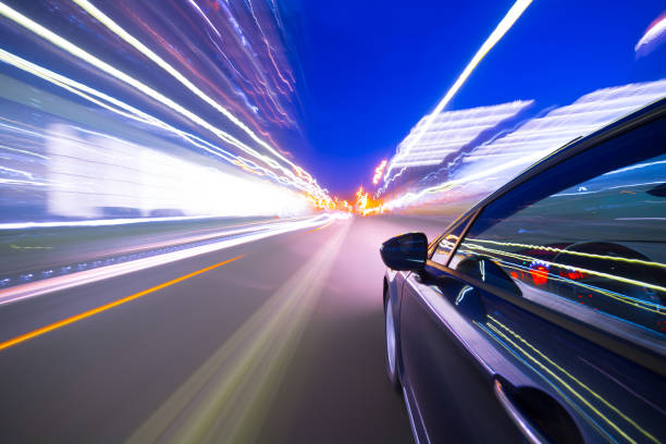 istock View from Side of Car moving in a night city 687283076