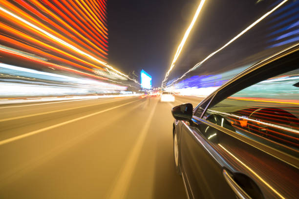 istock View from Side of Car moving in a night city 687293074