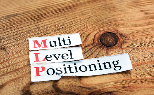 MLP- Multi Level Positioning written on paper on wooden background