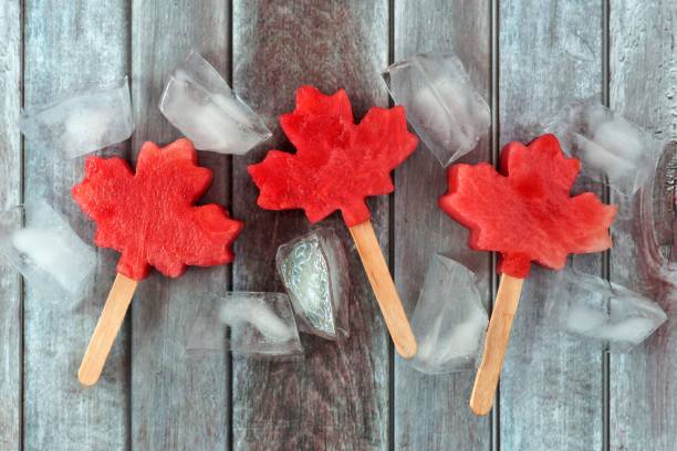 Canadian maple leaf watermelon pops on rustic wood