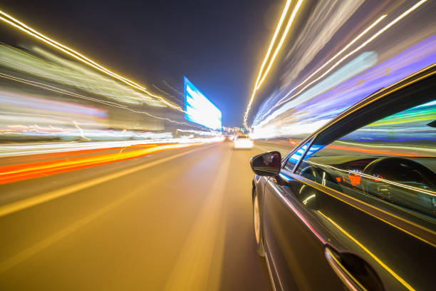 istock View from Side of Car moving in a night city 687302910
