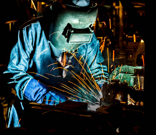istock Industrial Worker at the factory welding 687305902