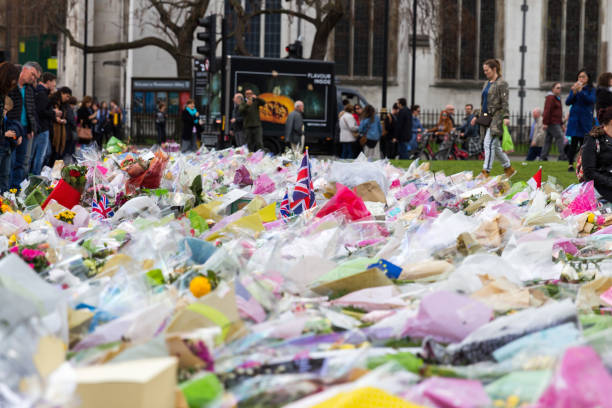 London, UK - 1st April, 2017: Parliament Square has been covered with flowers for those killed in terrorist attack, London, Uk. London, UK - 1st April, 2017: Parliament Square has been covered with flowers for those killed in terrorist attack, London, Uk. islamic state stock pictures, royalty-free photos & images