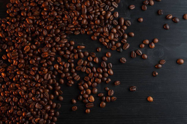 istock Fried coffee grains a wooden background 687309388