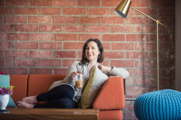 istock Young Woman Listening to a Podcast 687309556
