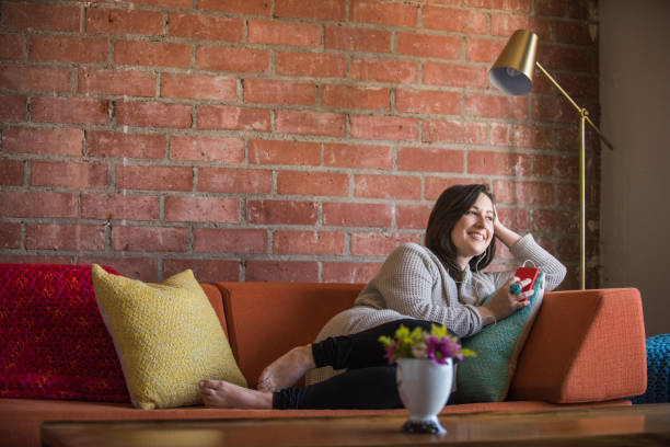 istock Young Woman Listening to a Podcast 687309624
