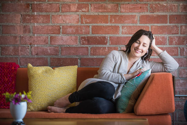 istock Young Woman Listening to a Podcast 687309638