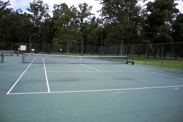 istock Worn Tennis Court at Public Park 687309908