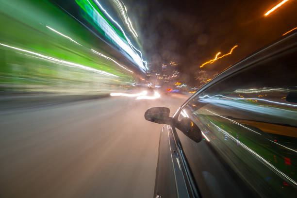 istock View from Side of Car moving in a night city 687310096
