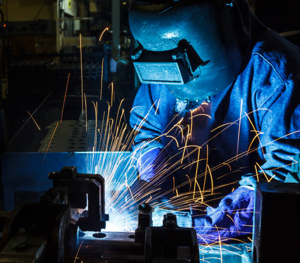istock Industrial Worker at the factory welding 687310438