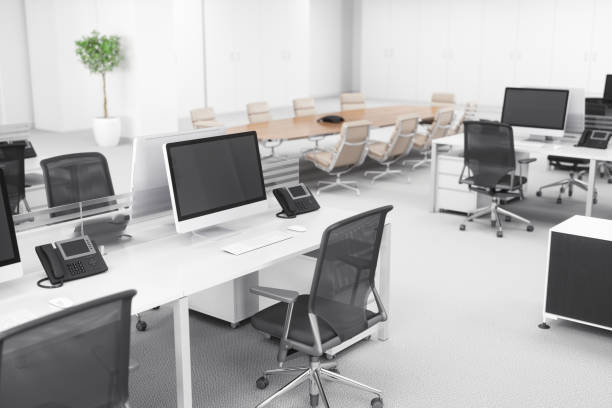 Office Desk In A Modern Office Interior Office desks and computers in an empty modern open office space with carpet floor. giant cube stock pictures, royalty-free photos & images
