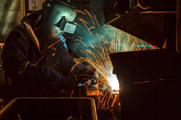istock Industrial Worker at the factory welding 687313064