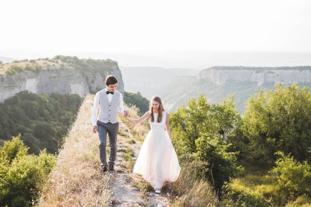 istock Wedding couple walking in the mountains with stunning views 687313096