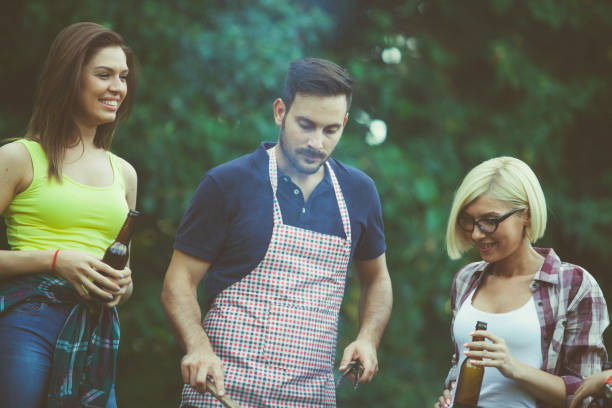 istock Friends preparing food on grill 687315486