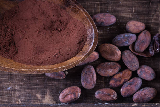 istock Cacao powder and beans over rustic wooden background 687316124