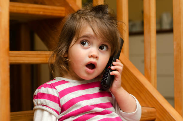 little girl speaks on the phone - one baby girl only fotos imagens e fotografias de stock