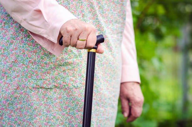 istock Old obese woman walking with stick 687318702
