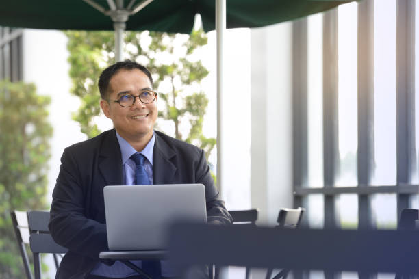 istock Executive businessman  working with laptop computer at outdoor cafe 687328912