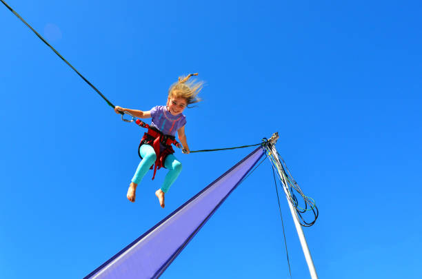 istock Little girl on Bungee trampoline 687329134