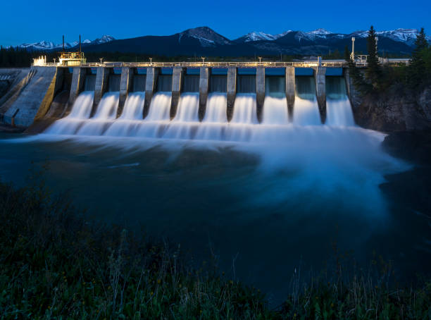 Seebe Hydroelectric Dam near Exshaw at Night The Seebe Dam near Exshaw in Alberta Canada is used to produce hydroelectricity. falling water flowing water stock pictures, royalty-free photos & images