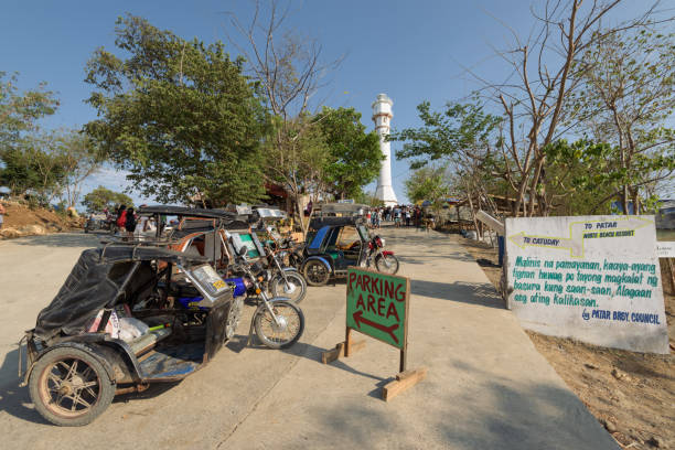 Cape Bolinao Lighthouse Pangasinan, Philippines - April 13, 2017: Visitors at  Cape Bolinao Lighthouse in Pangasinan, Philippines. pangasinan stock pictures, royalty-free photos & images