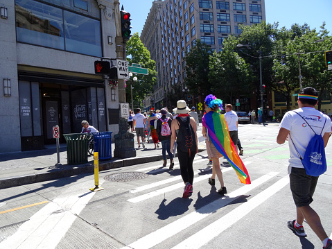 SEATTLE - JUNE 26: Young people cross street dressed up for Seattle Gay Pride Parade June 26, 2016