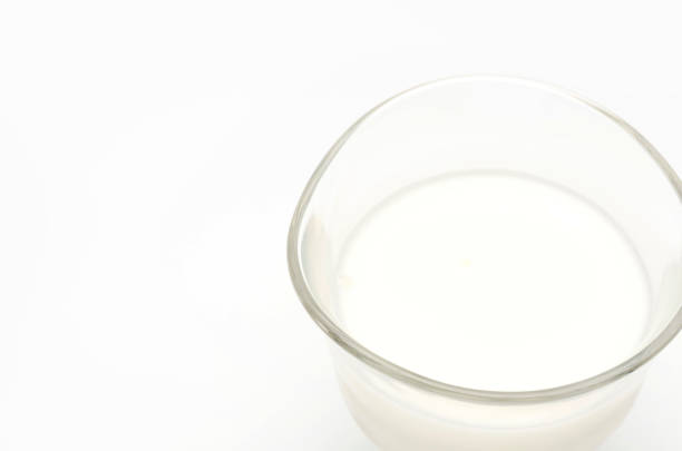istock Glass of milk isolated on white 687343912
