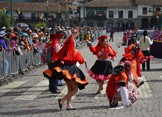 Inti Raymi Dancers Tourists and locals looking at female Inti Raymi (festival of the sun)dancers in traditional dress and hats on the main square of Cusco, Peru. inti raymi stock pictures, royalty-free photos & images