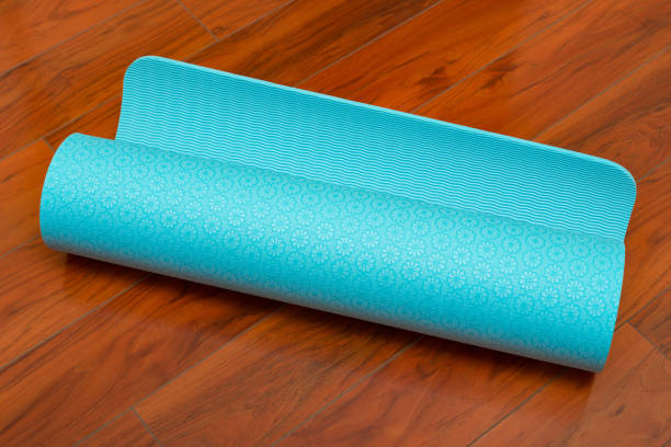 istock rolled blue yoga met on wooden floor 687356530