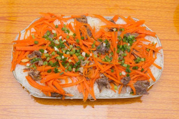 top view home cooked rice noodles with carrot slices and beef