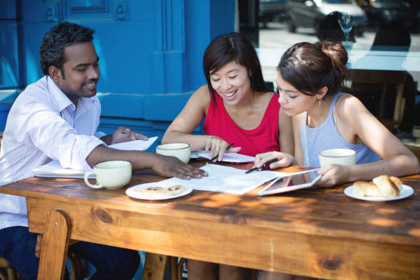 istock Multi-ethnic group of adult students having coffee at a cafe 687359918
