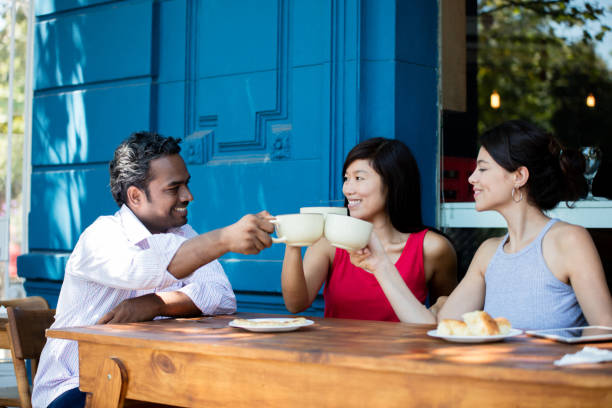 istock Friends making a toast with coffee at a cafe 687359920