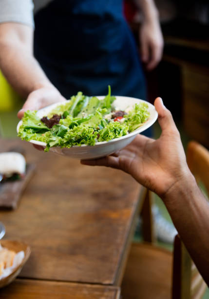 istock Waiter serving food at a restaurant 687360068