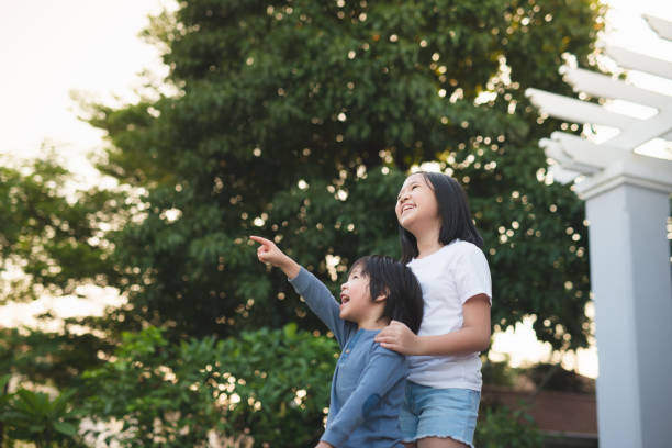 istock Asian child looking up outdoors 687363926