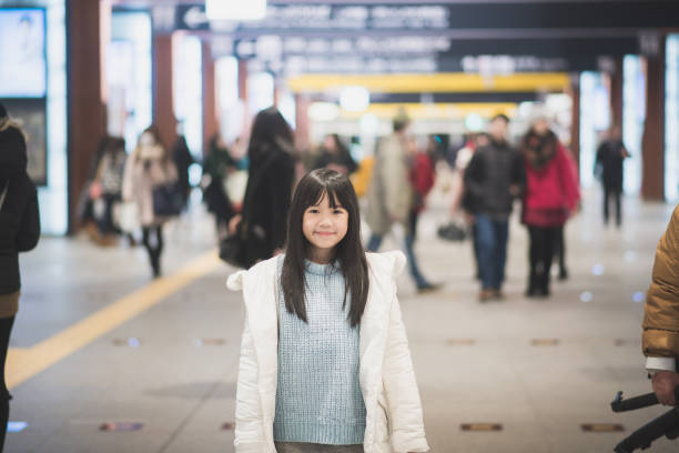 istock Asian girl waiting for train 687371994