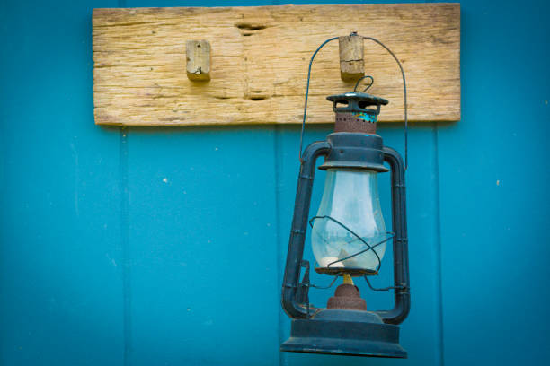 Burning kerosene lamp hang on the wooden wall